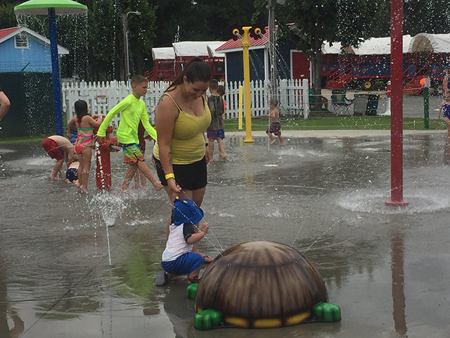 Mother and child playing in the water at the Family Fun Day in Youngsville